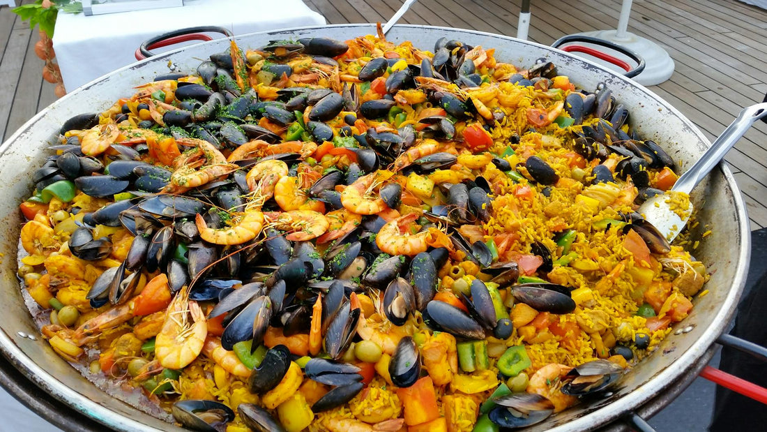 Spanish seafood paella in a traditional pan with prawns, mussels and saffron rice
