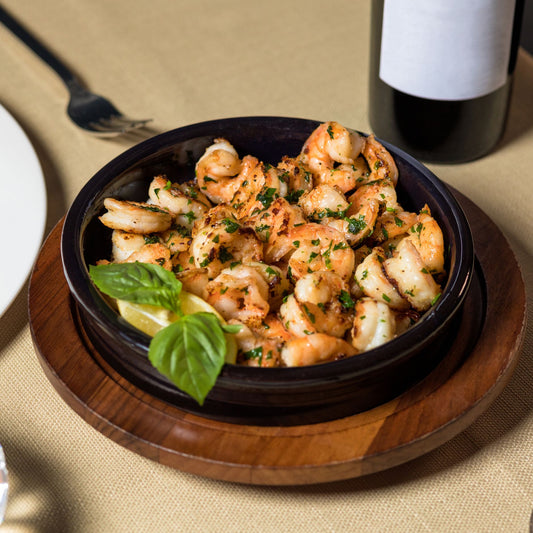 Gambas al ajillo — Spanish garlic shrimp sizzling in a clay cazuela