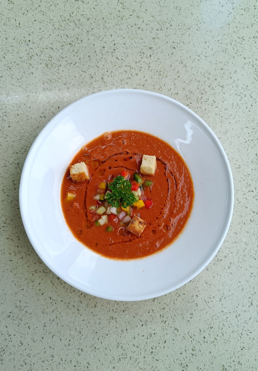 A bowl of Andalusian gazpacho — chilled tomato soup with croutons and diced vegetables