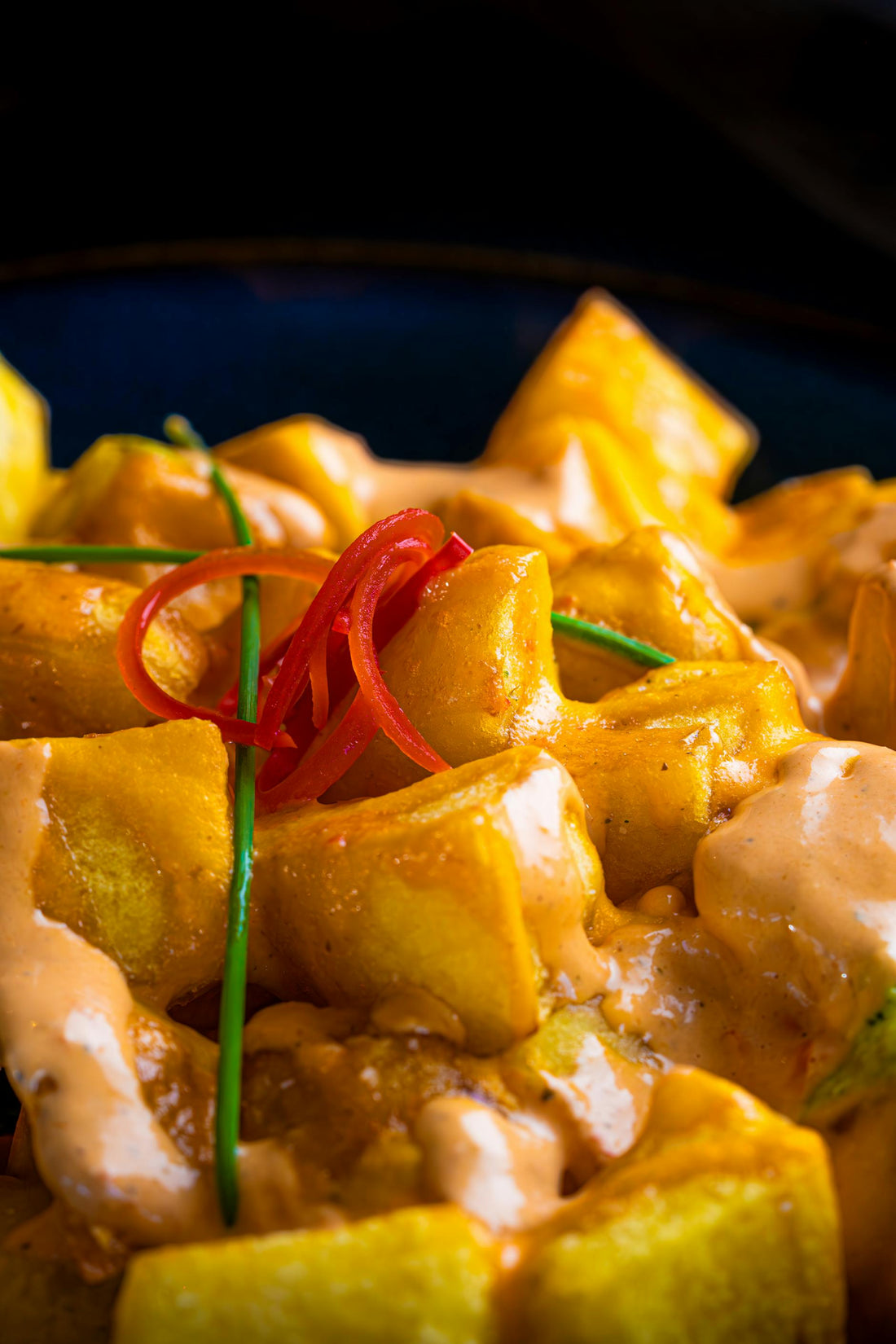 Patatas bravas — crispy Spanish potatoes with smoky brava sauce and aioli